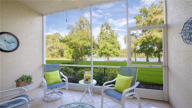 sunroom / solarium featuring a water view