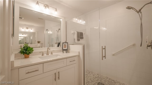 bathroom with vanity and a shower with shower door