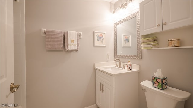 bathroom featuring toilet and vanity