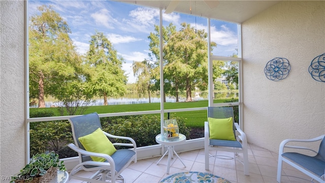 sunroom / solarium featuring a water view