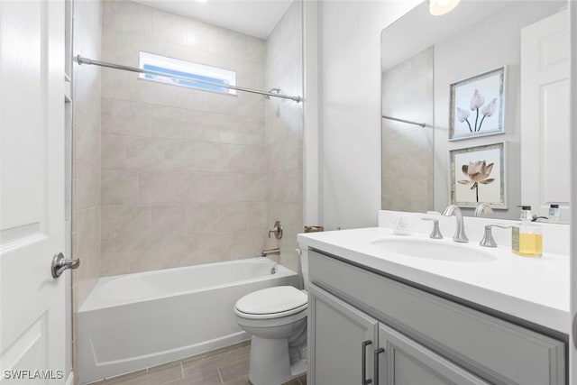 bathroom featuring toilet, tub / shower combination, wood finished floors, and vanity