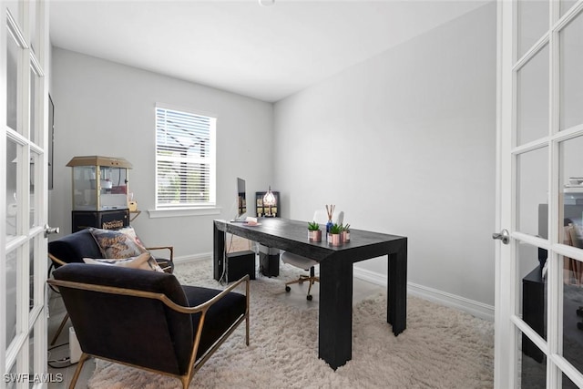 office space with baseboards and french doors