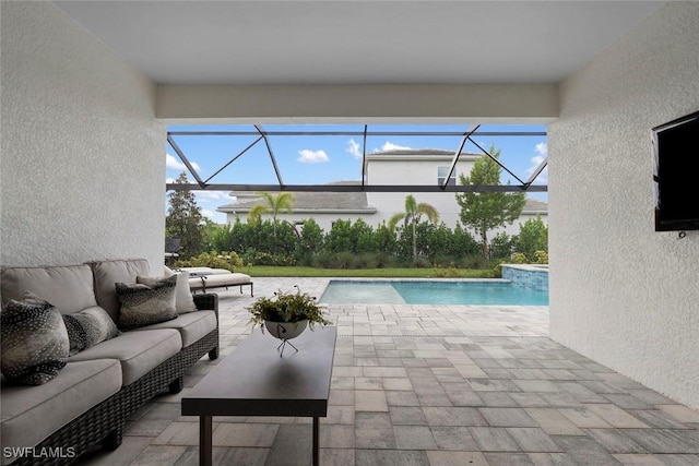 exterior space with a patio area, glass enclosure, and outdoor lounge area