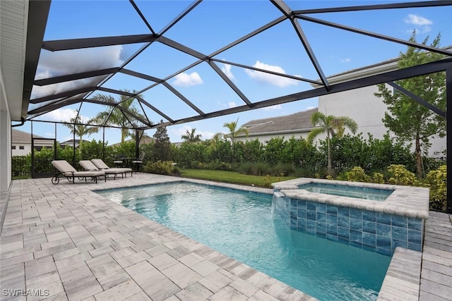 view of swimming pool featuring a pool with connected hot tub, glass enclosure, and a patio