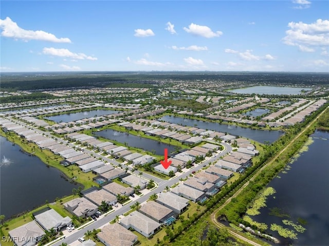 drone / aerial view with a water view and a residential view