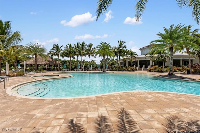 community pool with a patio and a gazebo