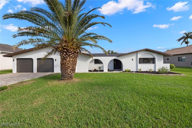 view of front of house featuring a front yard and a garage