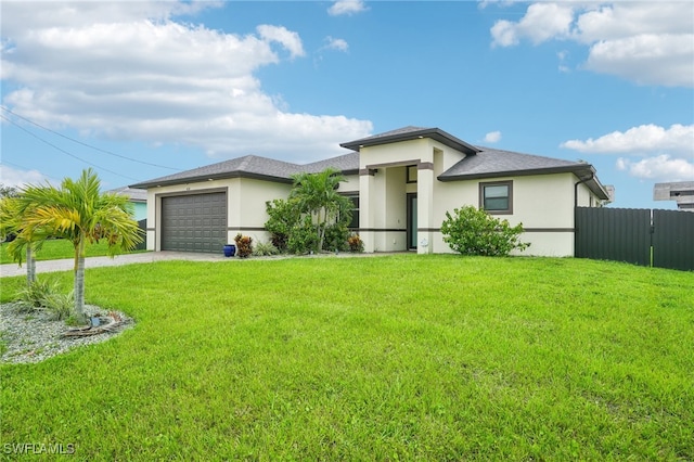 prairie-style home with a front yard and a garage