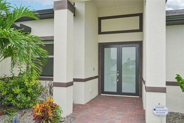 view of exterior entry featuring french doors