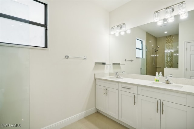 bathroom with double sink vanity, walk in shower, and tile patterned floors