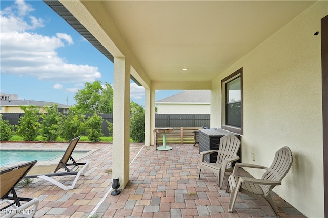 view of patio / terrace with a fenced in pool