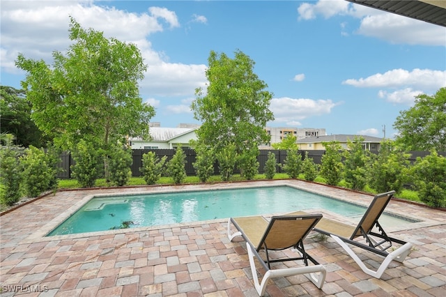 view of swimming pool featuring a patio area