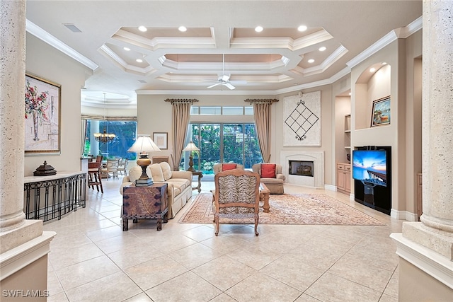 living room with ceiling fan with notable chandelier, coffered ceiling, ornate columns, a high end fireplace, and ornamental molding