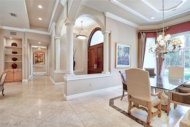 tiled dining space featuring ornate columns, crown molding, a chandelier, a raised ceiling, and built in features