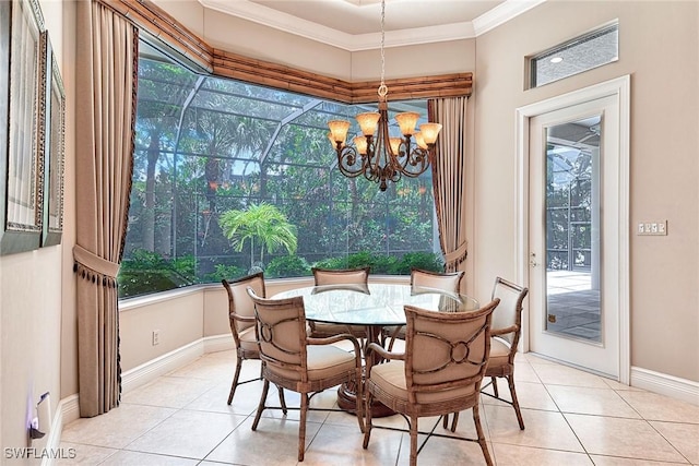 tiled dining space with an inviting chandelier, plenty of natural light, and ornamental molding