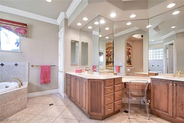 bathroom with tiled tub, ornamental molding, vanity, and tile patterned floors