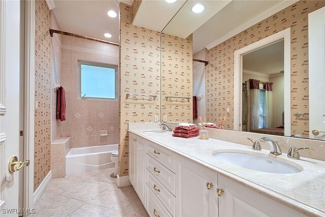 full bathroom featuring tiled shower / bath combo, ornamental molding, vanity, toilet, and tile patterned floors