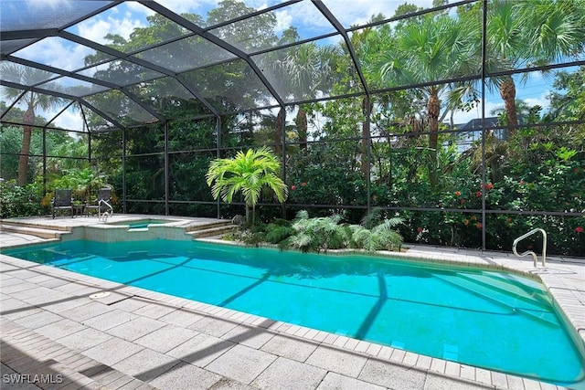 view of pool featuring an in ground hot tub, a lanai, and a patio