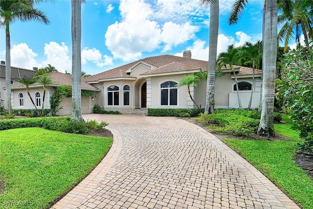 view of front of property with a garage and a front yard