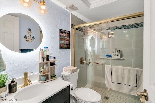 bathroom featuring a shower with shower door, toilet, ornamental molding, and vanity