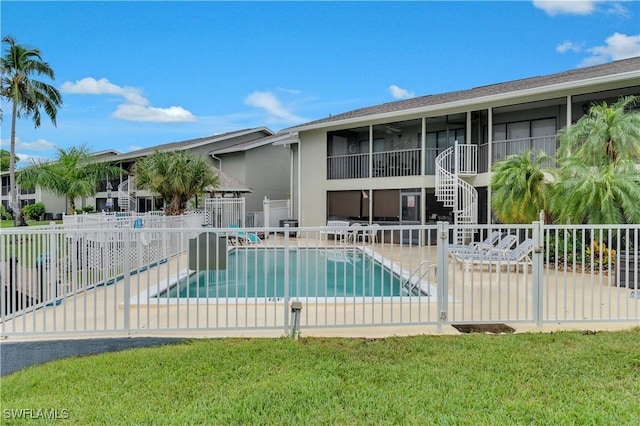 view of swimming pool featuring a lawn and a patio area