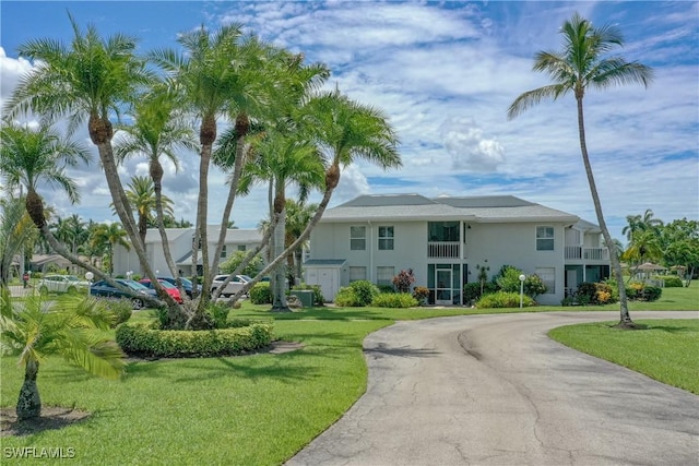 view of front of property with a balcony and a front yard