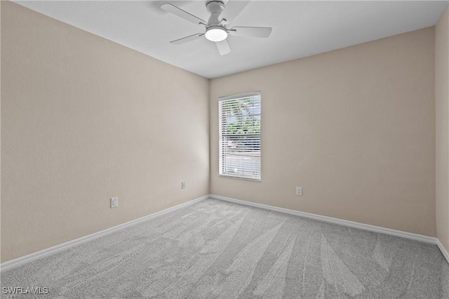 spare room featuring ceiling fan and light colored carpet