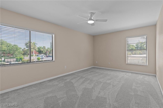 empty room featuring light carpet and ceiling fan