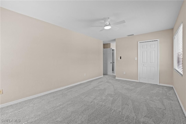 unfurnished bedroom featuring light carpet and ceiling fan