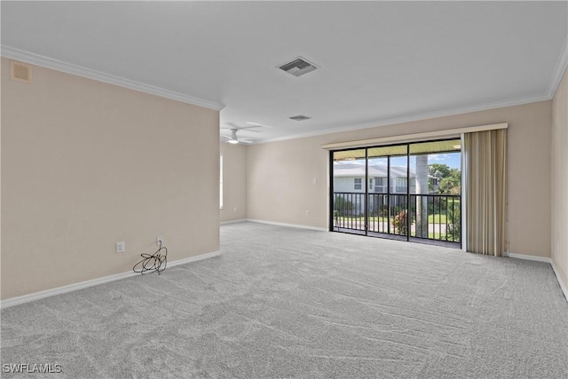 carpeted spare room with ceiling fan and ornamental molding