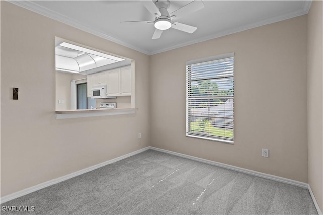 spare room featuring crown molding, light colored carpet, and ceiling fan