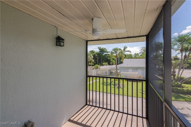 sunroom featuring ceiling fan