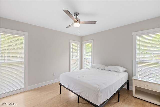 bedroom with ceiling fan and light hardwood / wood-style flooring