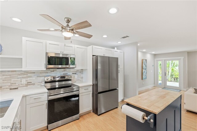 kitchen with white cabinets, ceiling fan, and stainless steel appliances