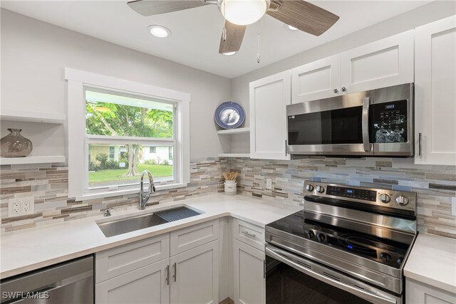 kitchen featuring white cabinets, sink, stainless steel appliances, and ceiling fan