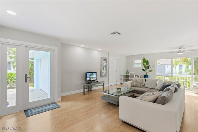 living room with ceiling fan and light hardwood / wood-style floors