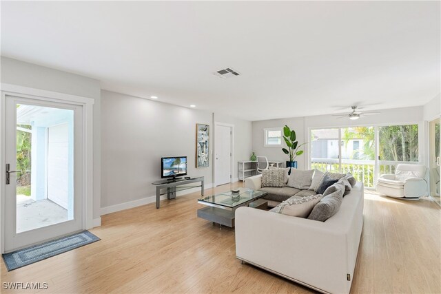 living room featuring ceiling fan and light hardwood / wood-style floors