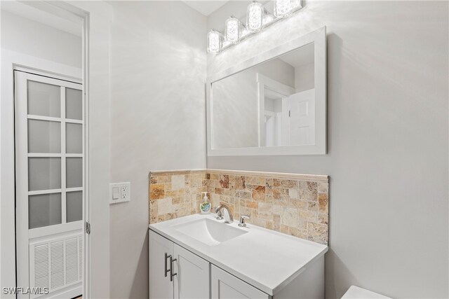 bathroom with backsplash and vanity