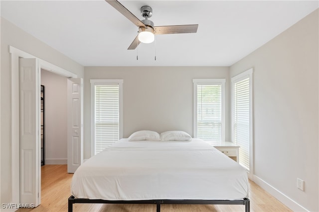 bedroom with ceiling fan and light hardwood / wood-style floors