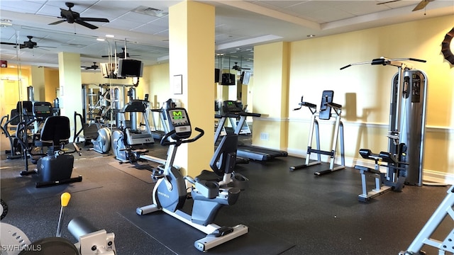 gym featuring a drop ceiling and ceiling fan