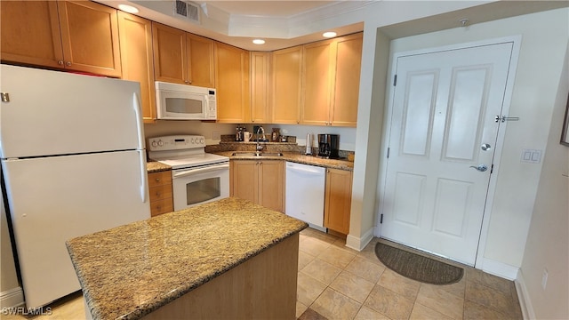 kitchen with white appliances, sink, light stone counters, light tile patterned floors, and ornamental molding