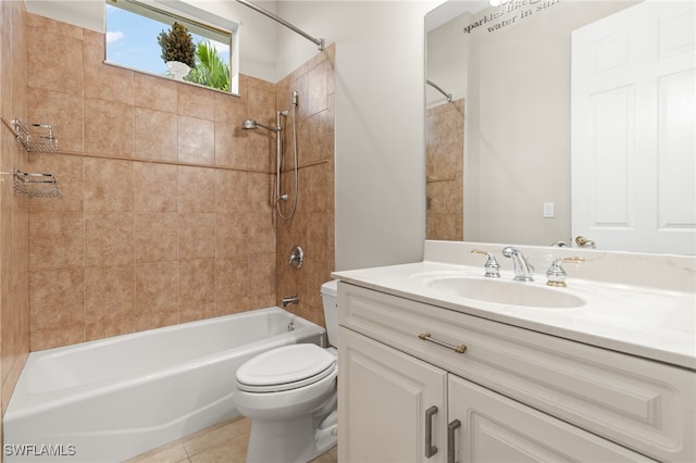 full bathroom with vanity, tile patterned flooring, tiled shower / bath combo, and toilet