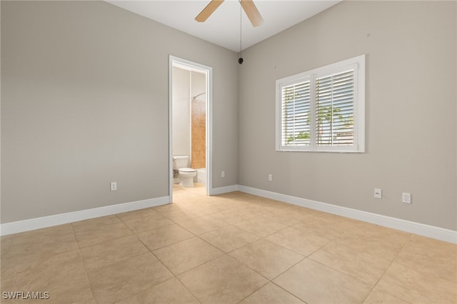 tiled empty room featuring ceiling fan