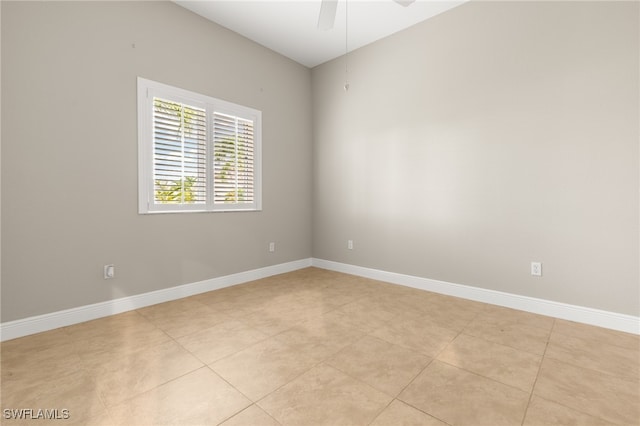 tiled empty room featuring ceiling fan