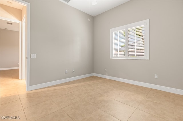 empty room featuring light tile patterned floors and ceiling fan