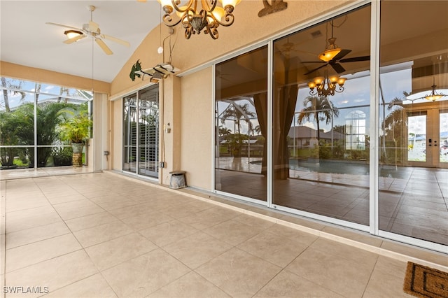 unfurnished sunroom featuring french doors and ceiling fan with notable chandelier