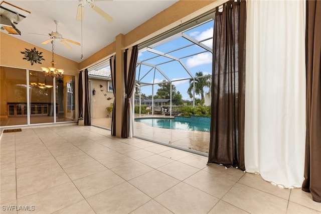 interior space with ceiling fan with notable chandelier and vaulted ceiling