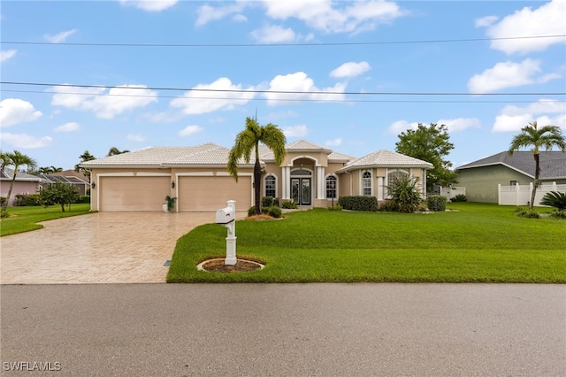 view of front of house with a garage and a front yard