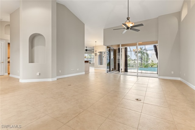 unfurnished living room with light tile patterned flooring, high vaulted ceiling, and ceiling fan