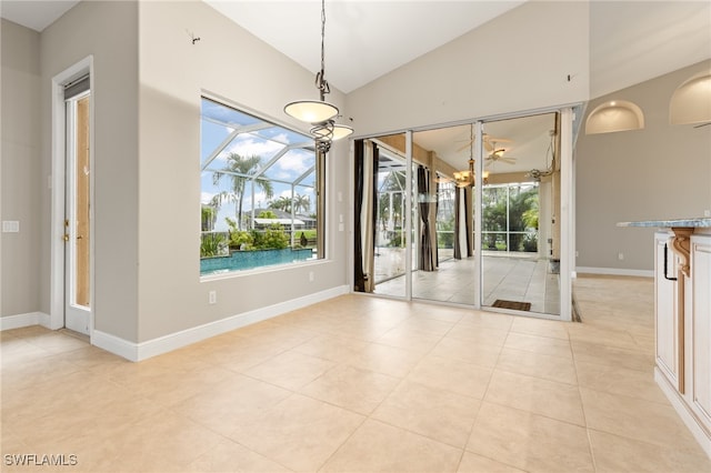 unfurnished dining area with lofted ceiling and light tile patterned floors